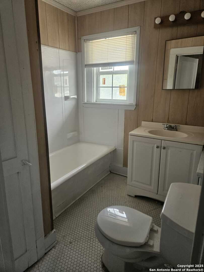 541 Hammond Avenue, Unit 4 San Antonio, TX 78210 - Photo 4 of 4 a bathroom with a toilet sink and mirror