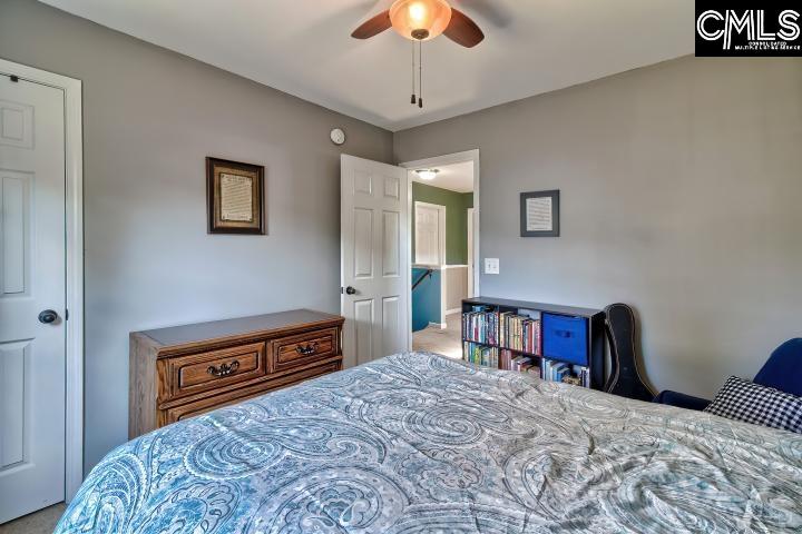 209 Eagle Pointe Drive Chapin, SC 29036 - Photo 24 of 40 a bedroom with a bed dresser and a chandelier