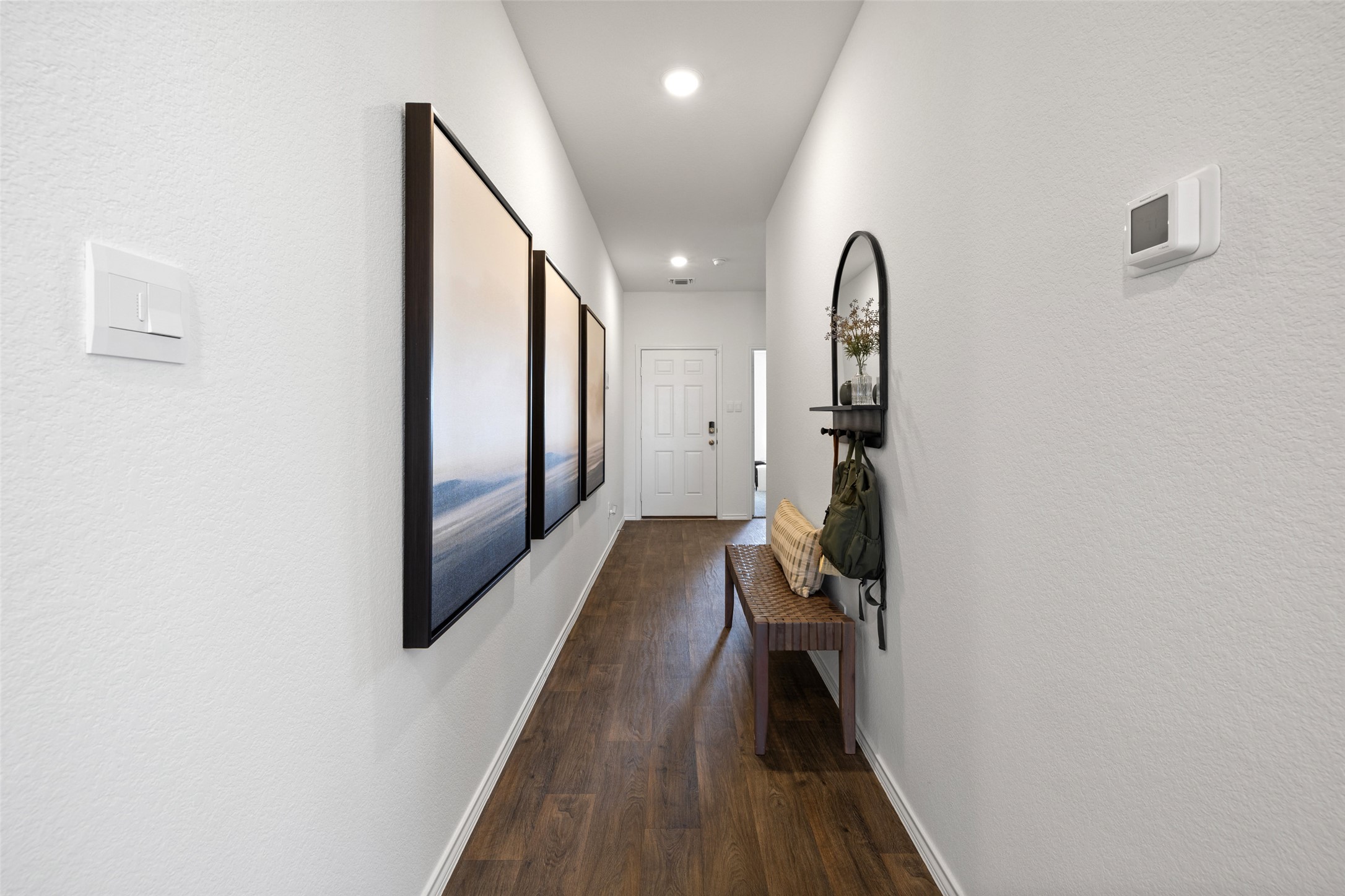 879 Arnold Loop Kyle, TX 78640 - Photo 31 of 33 a view of a hallway with wooden floor and staircase