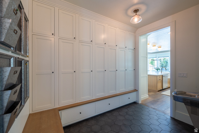 630 East Center Street Alpine, UT 84004 - Photo 25 of 115 Built-in white shaker-style cabinetry with black hardware, integrated bench seating, hexagonal dark tile flooring, recessed ceiling lighting, and a wide entryway