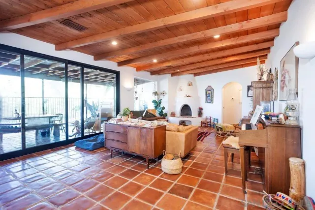 a living room with a large window and furniture