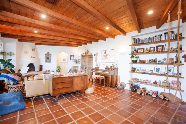 a room with fireplace furniture and a book shelf