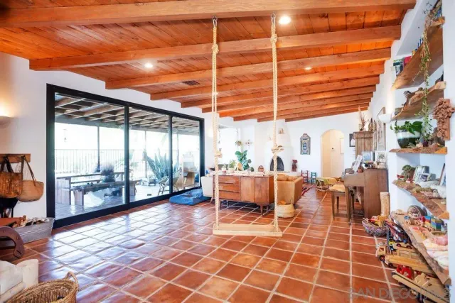 a bedroom with a bed and a large window with the outer view