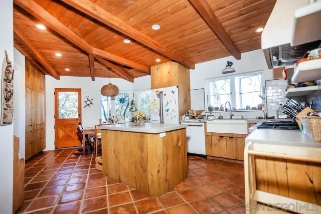 a view of a kitchen with furniture and wooden floor