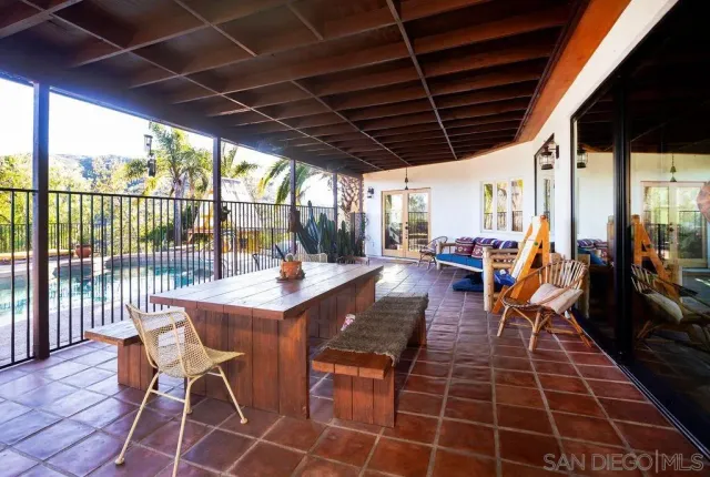 a outdoor space with lots of tables a large window and furniture