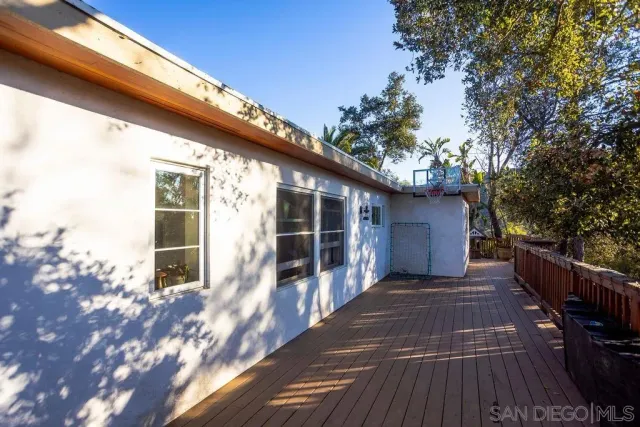 a view of backyard with swimming pool and patio