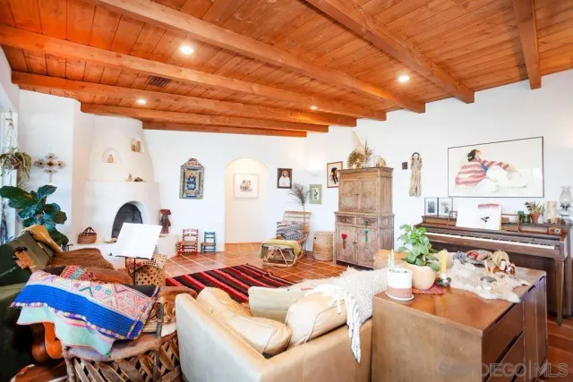 a living room with furniture a rug and a chandelier