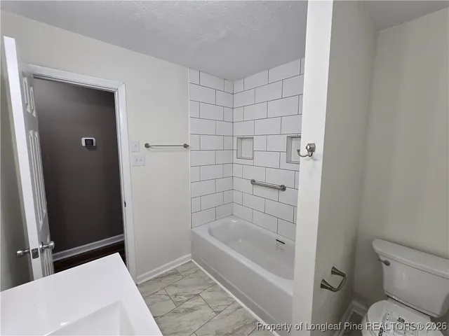 a bathroom with a bathtub and toilet