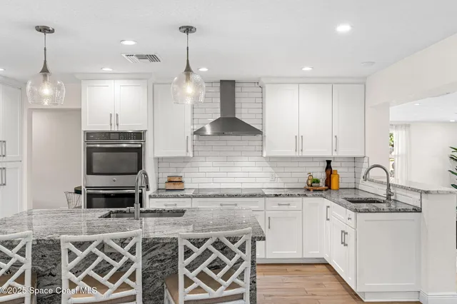a kitchen with sink stove and cabinets