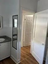 a bathroom with a granite countertop sink and shower