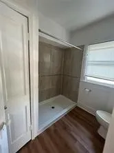 a bathroom with a glass shower door