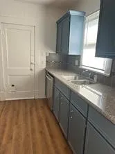 a view of a kitchen sink and a window