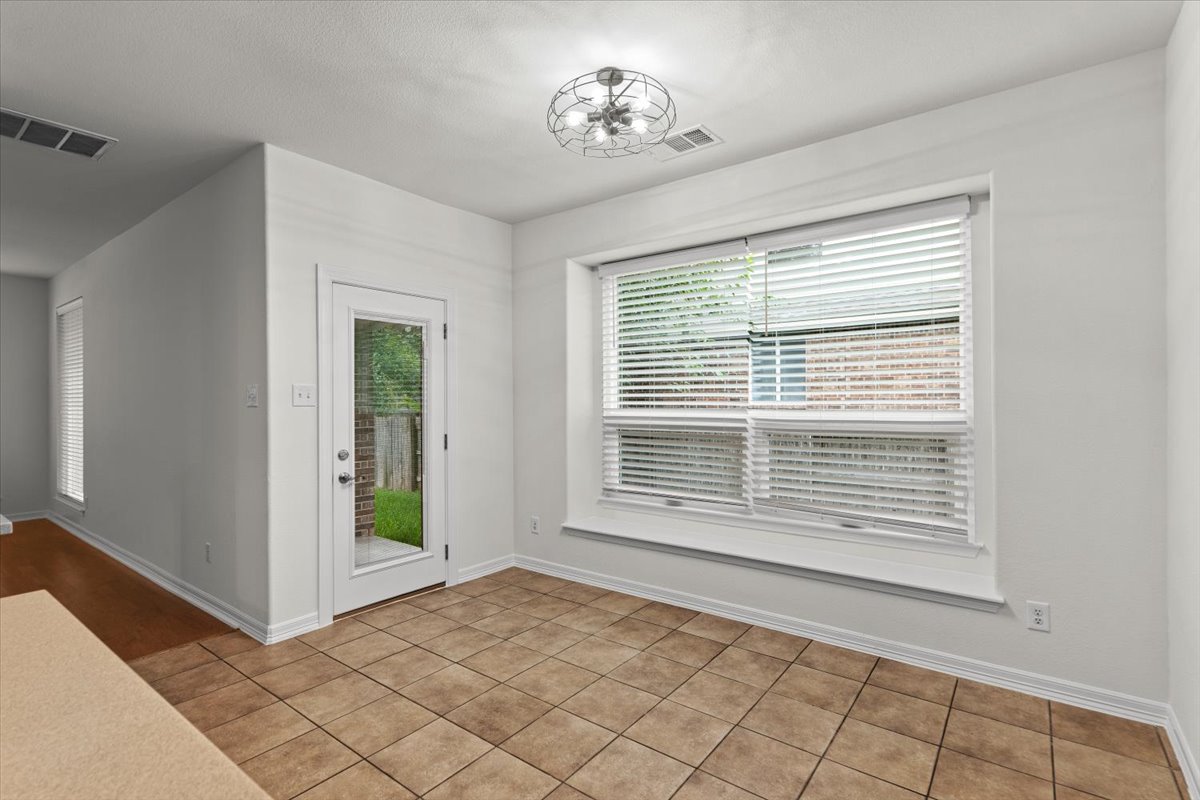 2304 Village View Loop Pflugerville, TX 78660 - Photo 11 of 40 Bright breakfast nook with tile flooring and direct outdoor access.