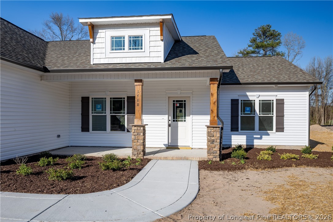 1788 Alderman Mill Road Dunn, NC 28334 - Photo 2 of 14 a front view of a house with garden