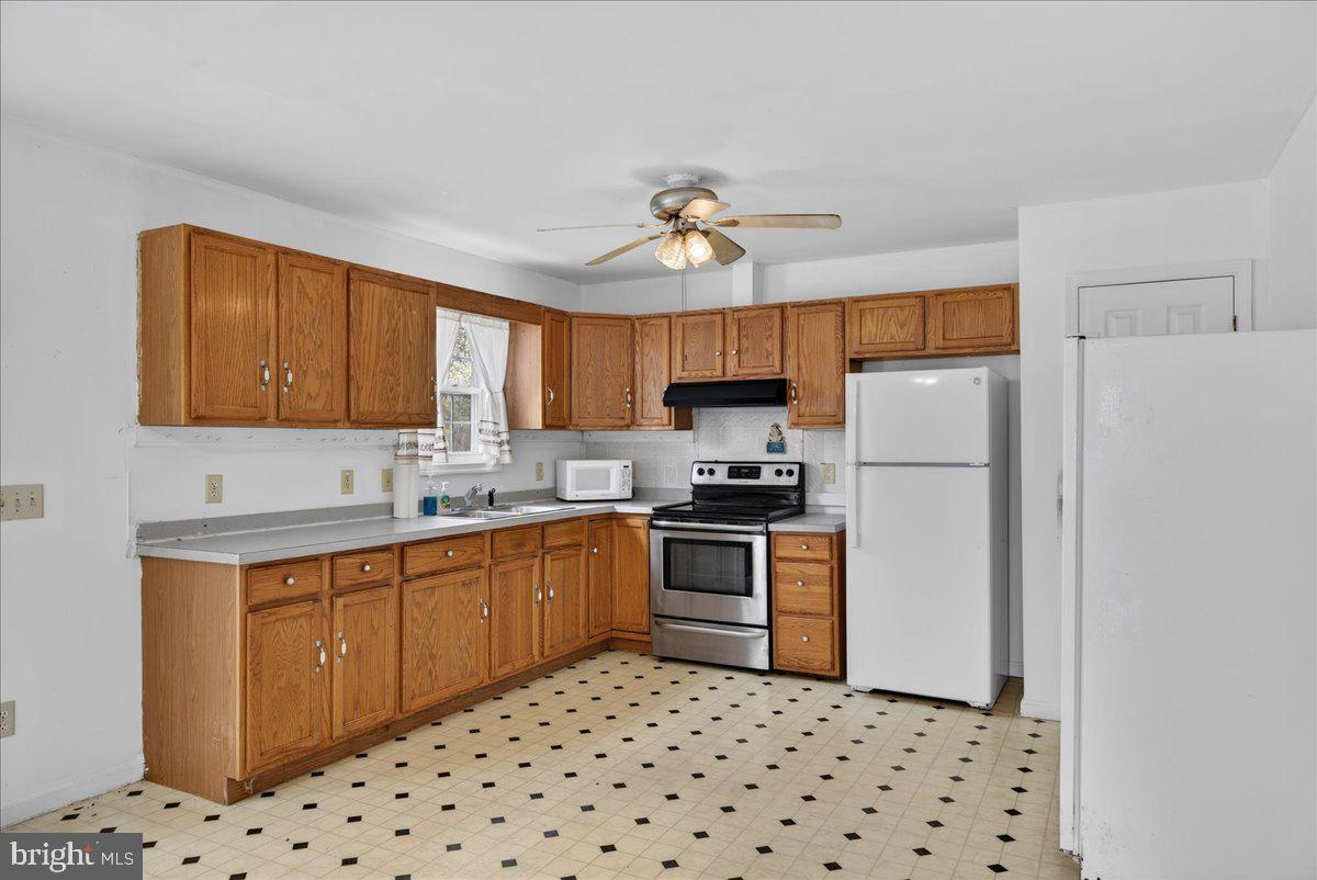 28042 Rapidan Road Rapidan, VA 22733 - Photo 12 of 72 a kitchen with stainless steel appliances a refrigerator sink and microwave