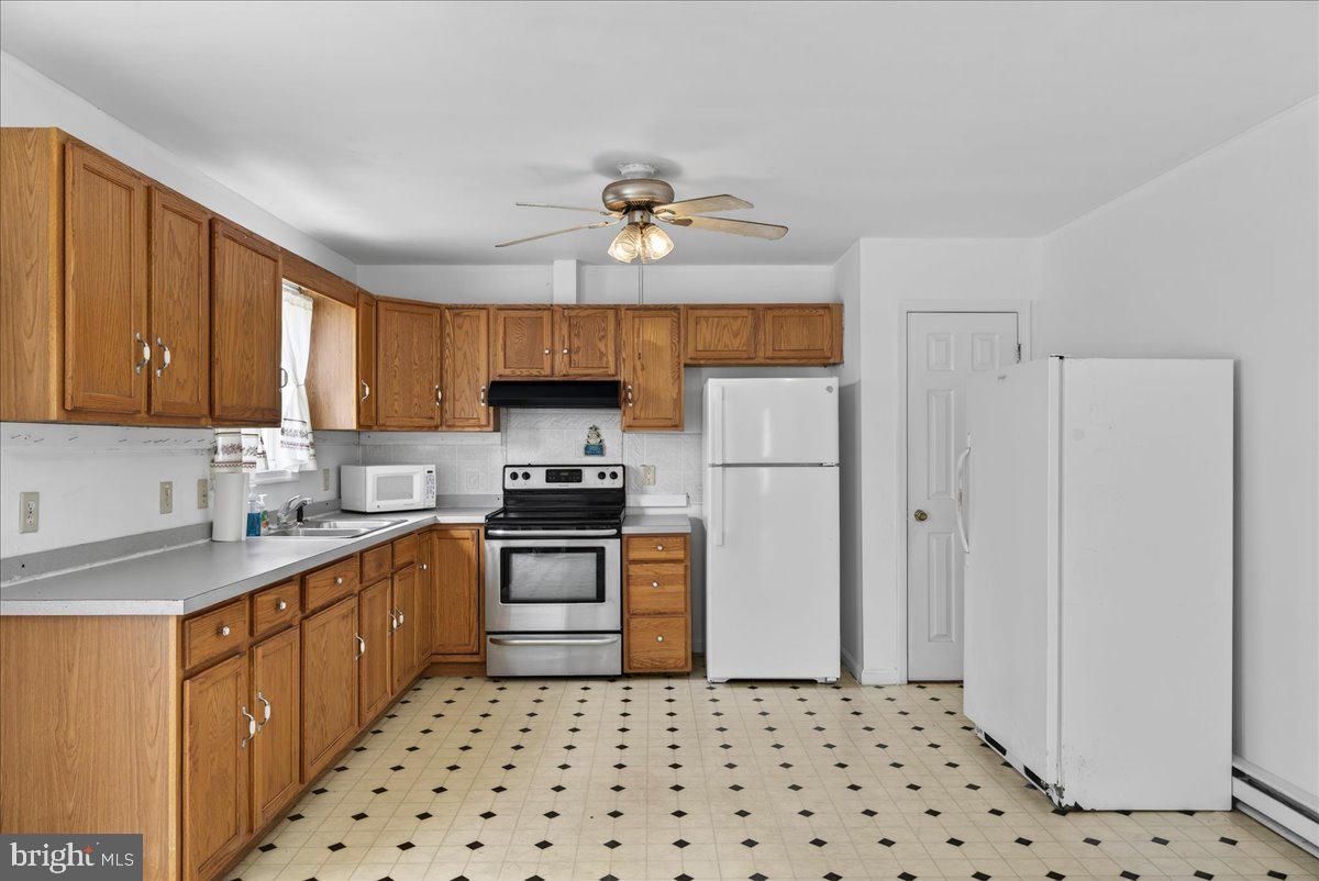 28042 Rapidan Road Rapidan, VA 22733 - Photo 13 of 72 a kitchen with stainless steel appliances a refrigerator a sink a stove a microwave and island