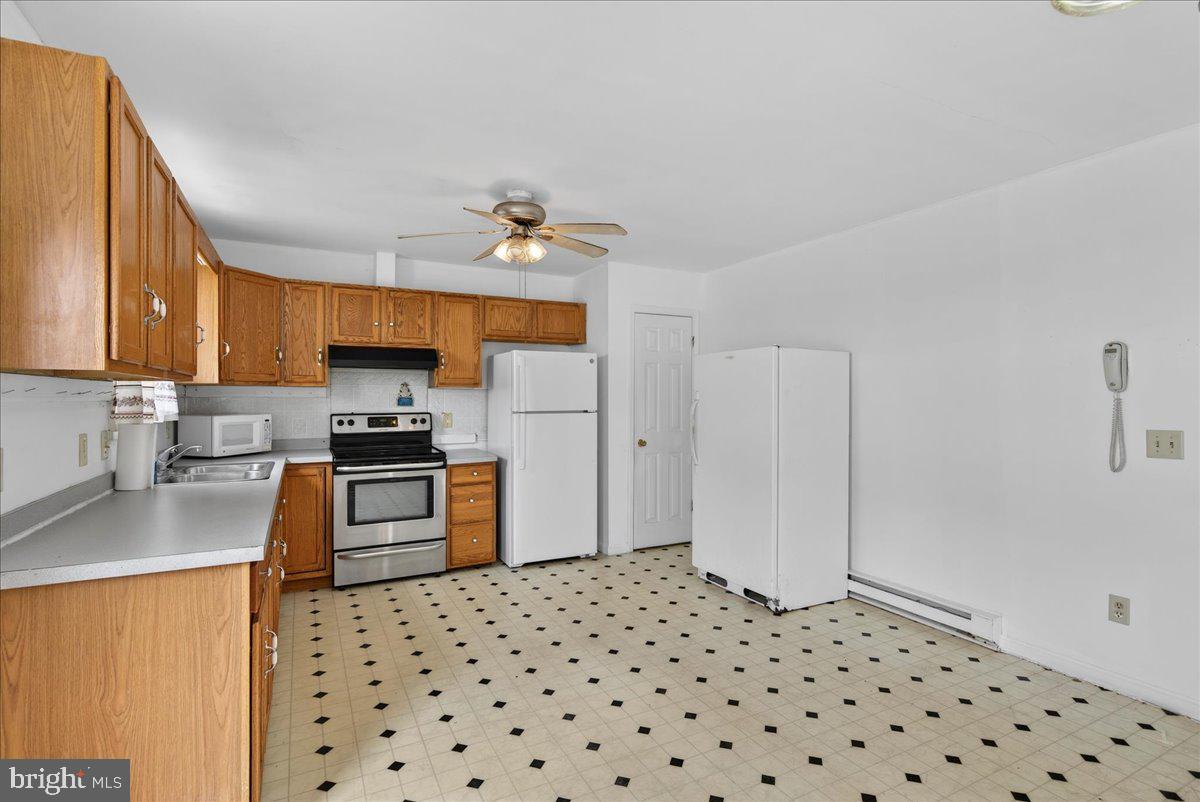 28042 Rapidan Road Rapidan, VA 22733 - Photo 10 of 72 a kitchen with granite countertop a refrigerator and a stove top oven