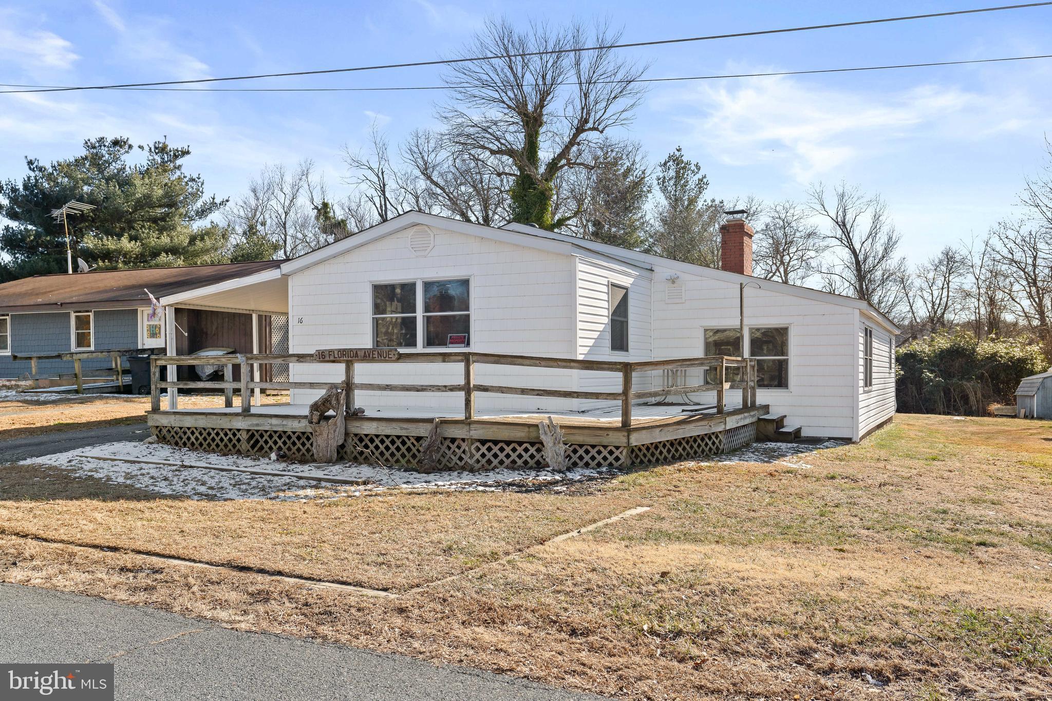 a white house that has a tree in front of it