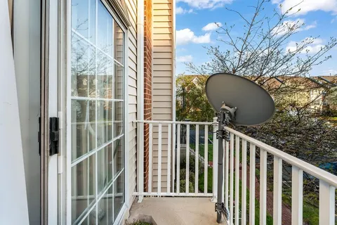 a view of a balcony with a small yard