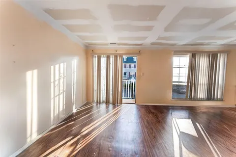 a view of entryway with wooden floor and walls