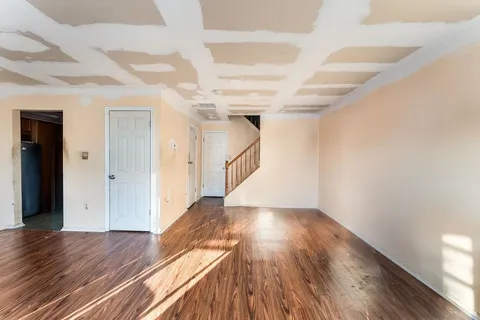 a view of an empty room with wooden floor
