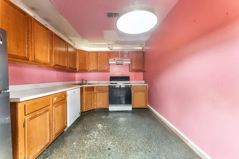 a kitchen with a stove a sink and a refrigerator