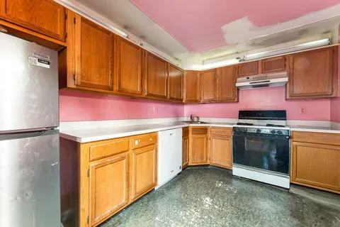 a kitchen with a stove top oven sink and cabinets