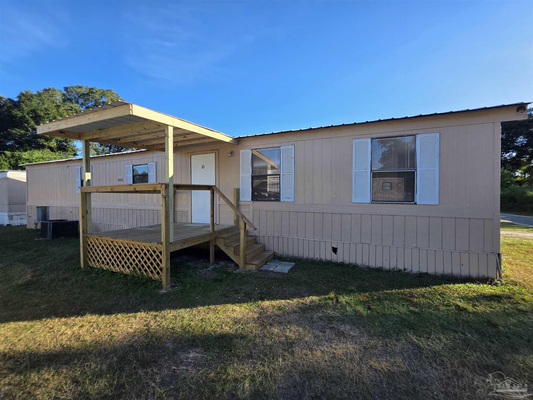 2821 Hillcrest Avenue, Unit 10 Pensacola, FL 32526 - Photo 1 of 14 a front view of a house with a yard