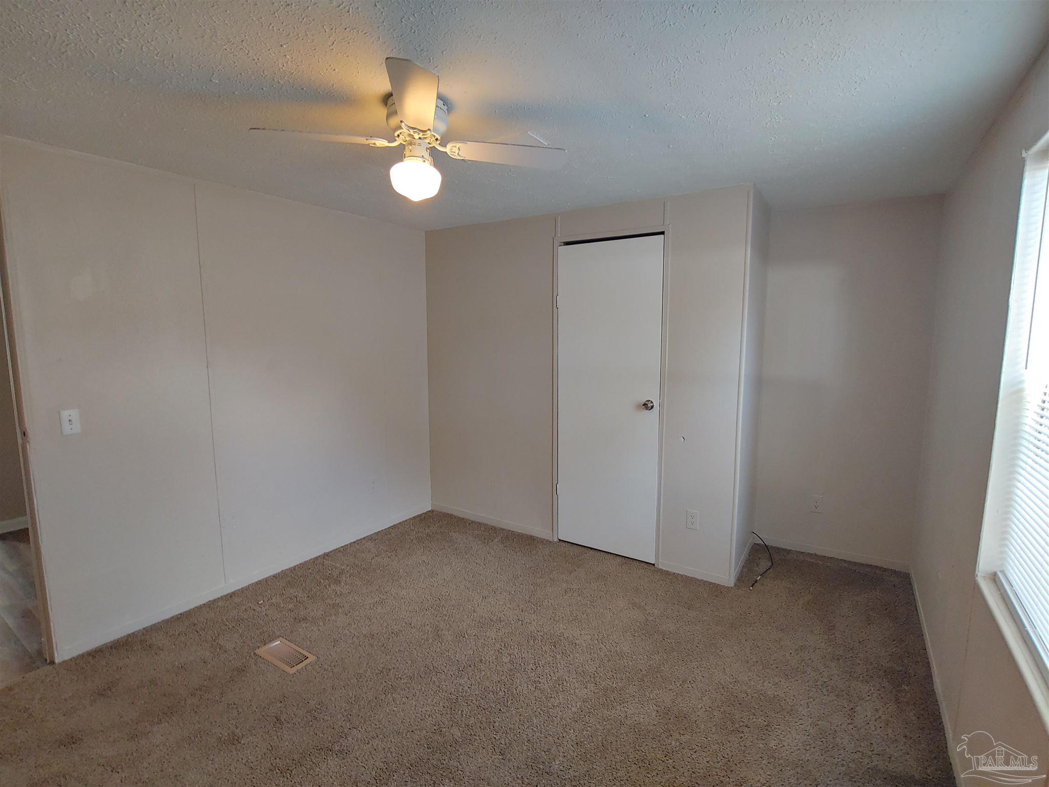 2821 Hillcrest Avenue, Unit 10 Pensacola, FL 32526 - Photo 12 of 14 a view of an empty room with a window