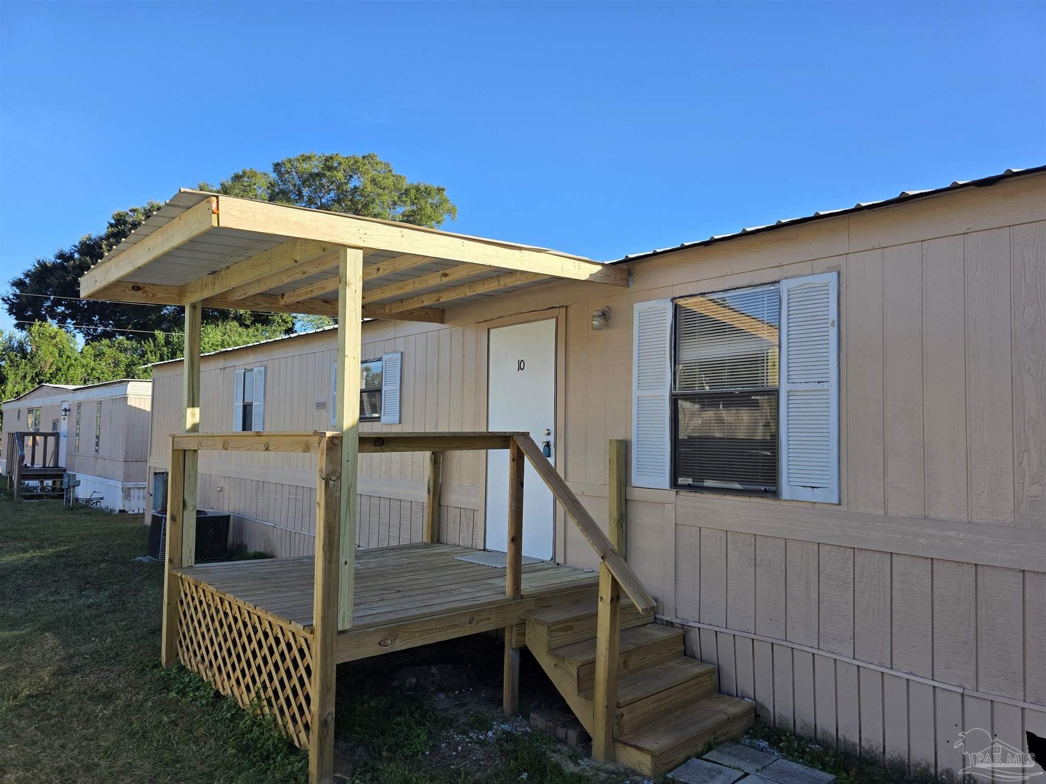 2821 Hillcrest Avenue, Unit 10 Pensacola, FL 32526 - Photo 2 of 14 a view of house with deck and outdoor seating