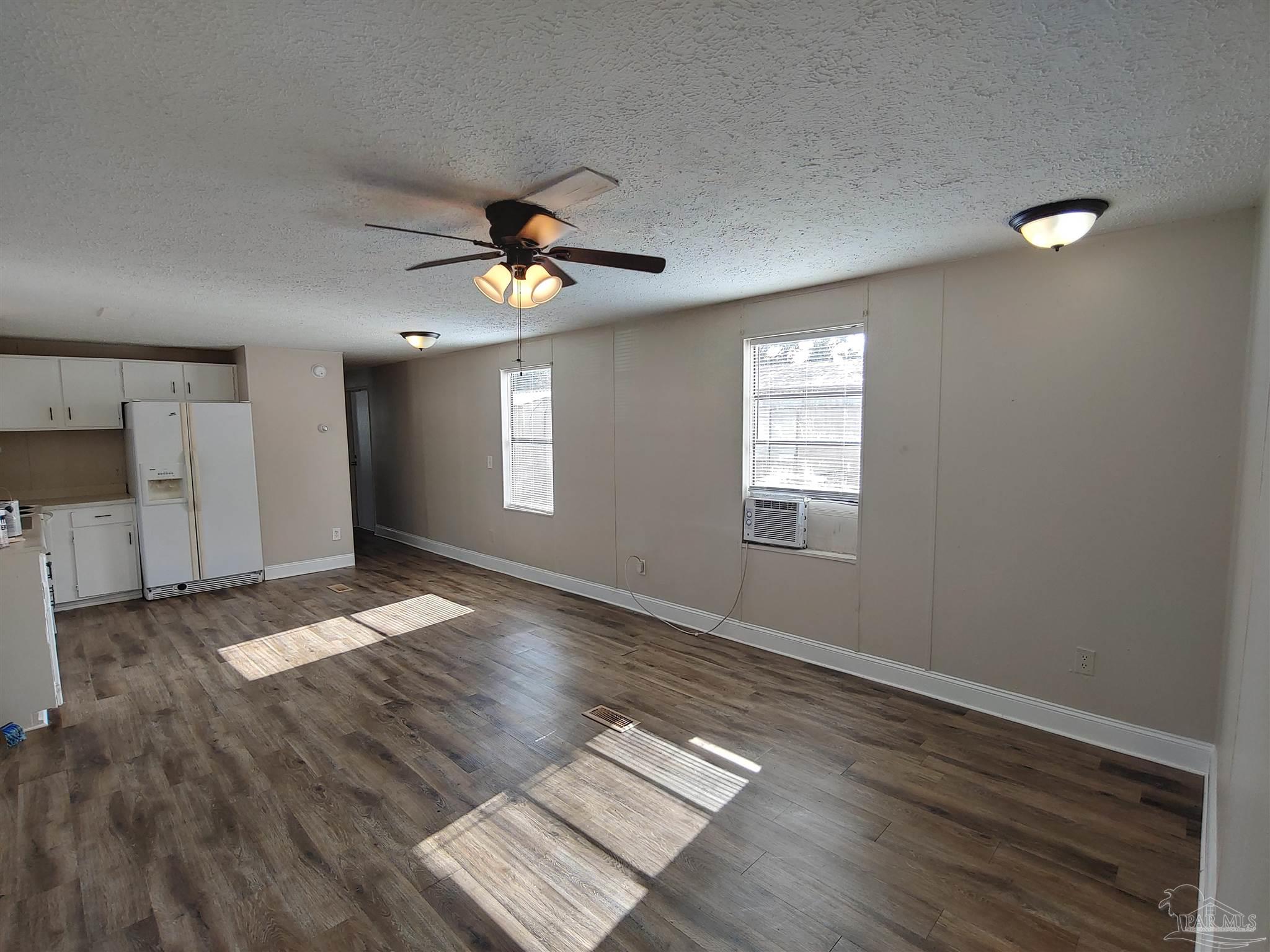 2821 Hillcrest Avenue, Unit 10 Pensacola, FL 32526 - Photo 3 of 14 a view of an empty room with window and wooden floor