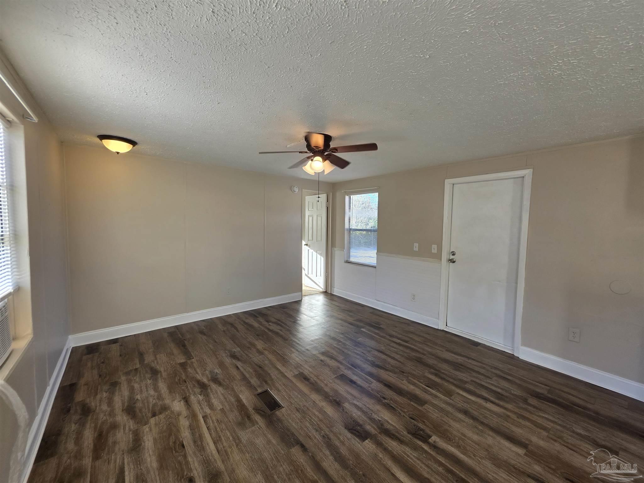 2821 Hillcrest Avenue, Unit 10 Pensacola, FL 32526 - Photo 4 of 14 wooden floor in an empty room with a window