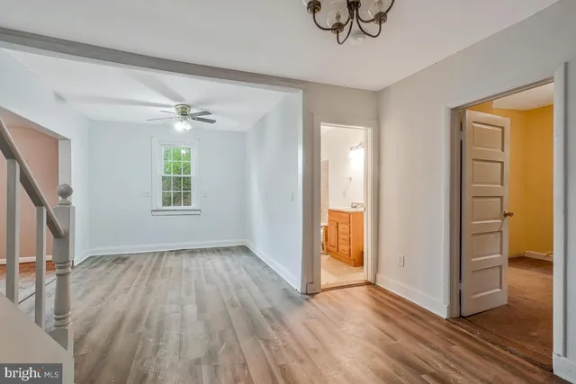 an empty room with closet and windows