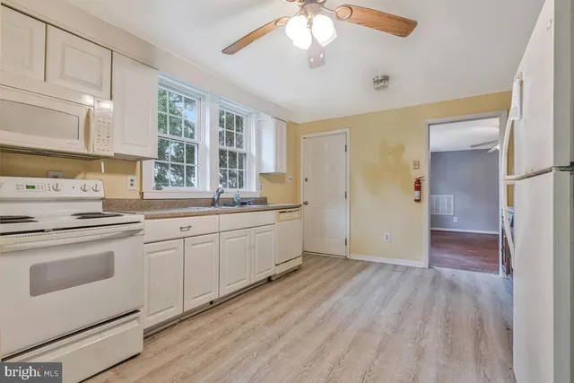 a kitchen with wooden cabinets and refrigerator