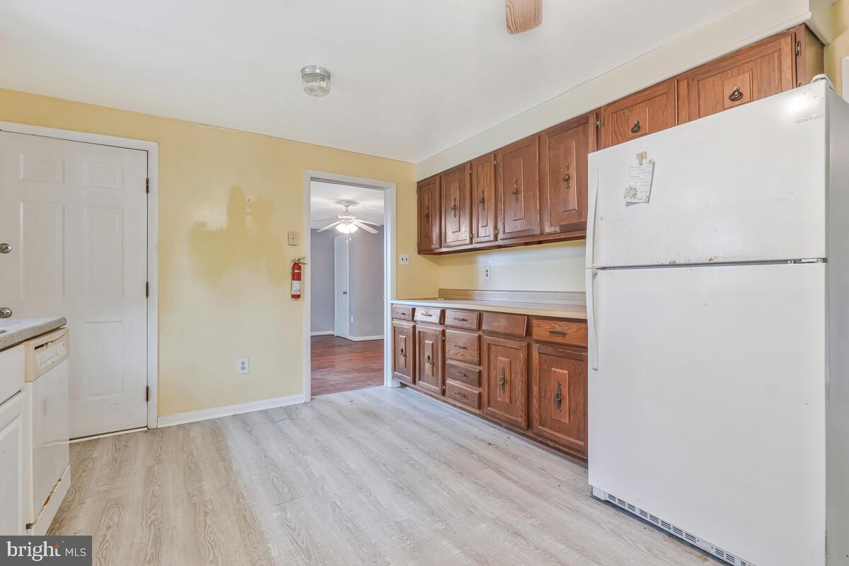 38888 Reeves Road Mechanicsville, MD 20659 - Photo 26 of 50 a kitchen with stainless steel appliances a refrigerator and a stove top oven