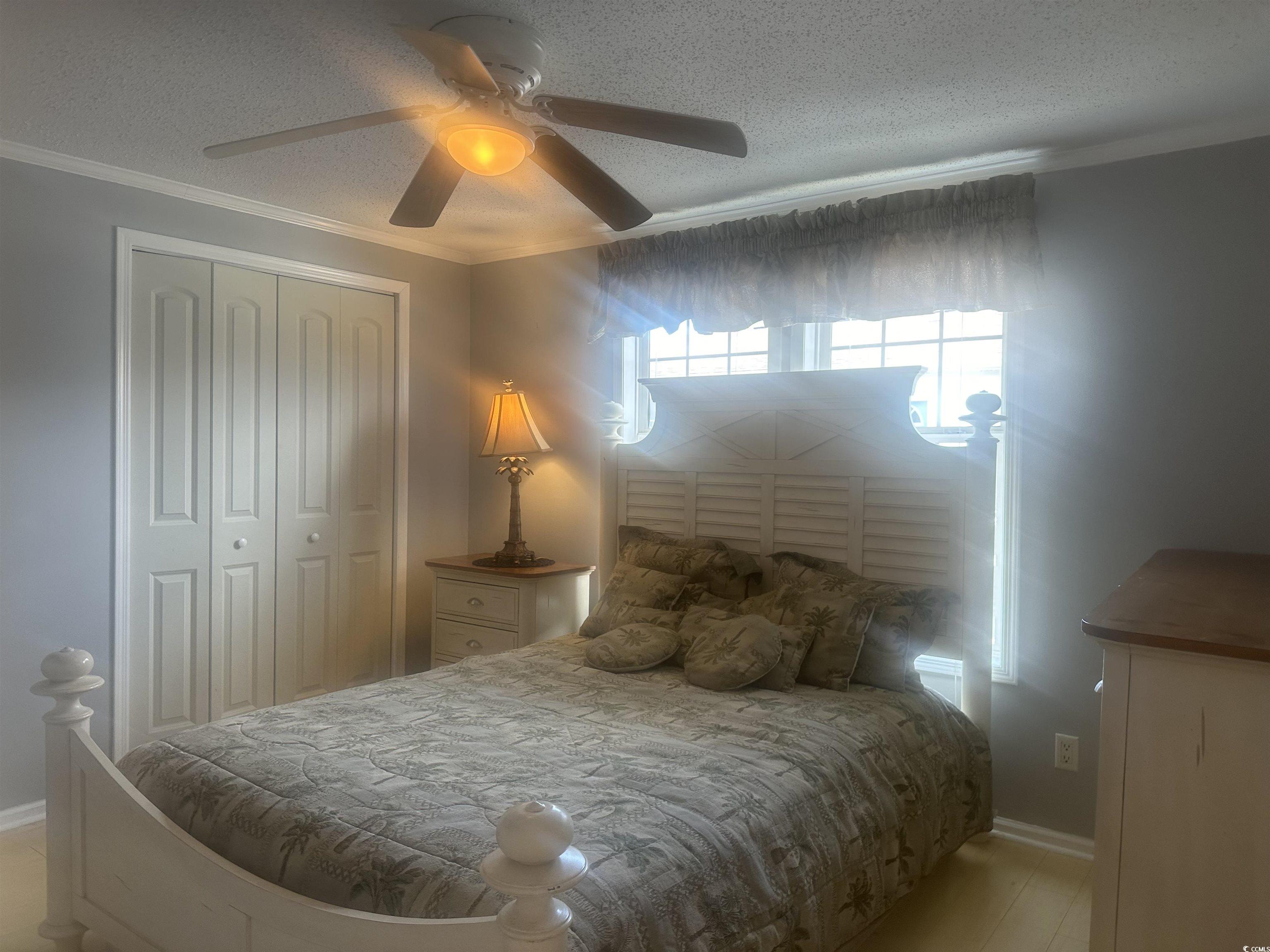 1752 Mason Circle Murrells Inlet, SC 29576 - Photo 7 of 31 Bedroom with ornamental molding, a closet, a textured ceiling, and ceiling fan