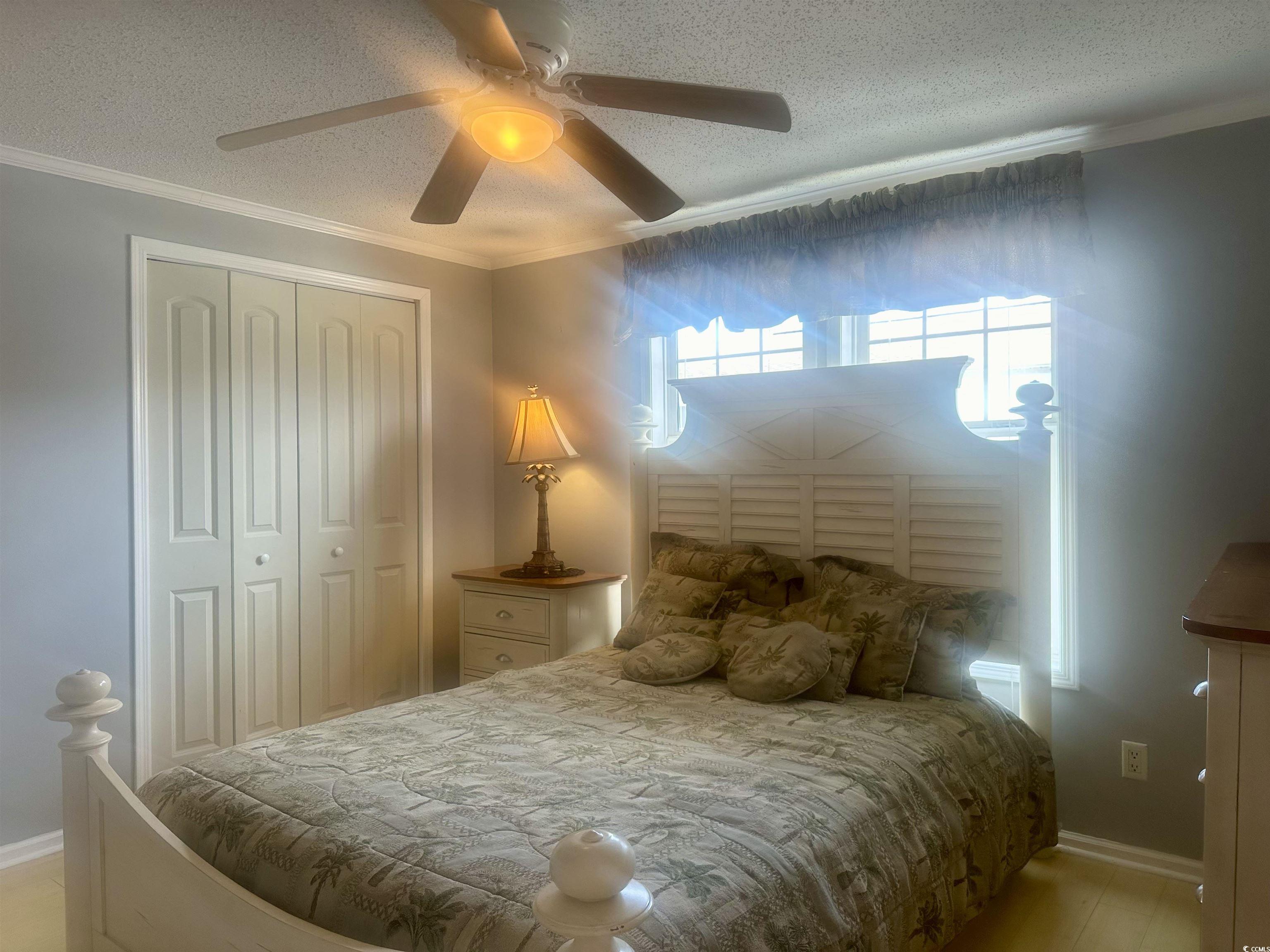 1752 Mason Circle Murrells Inlet, SC 29576 - Photo 8 of 31 Bedroom featuring a closet, multiple windows, ornamental molding, and ceiling fan