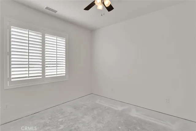 a view of a porch with furniture and floor to ceiling window