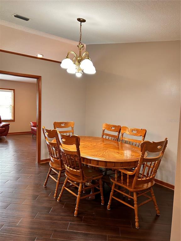 2284 Champlain Avenue Spring Hill, FL 34609 - Photo 12 of 28 a view of a dining room with furniture wooden floor and chandelier
