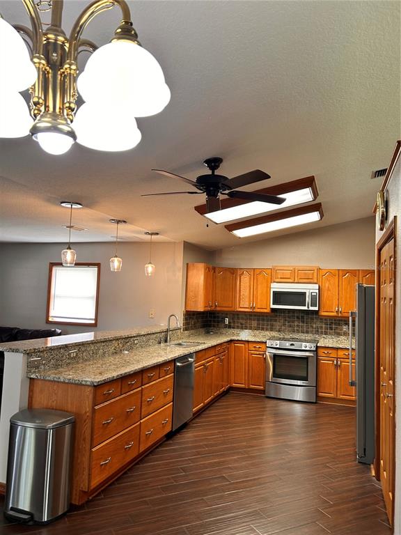 2284 Champlain Avenue Spring Hill, FL 34609 - Photo 13 of 28 a kitchen with stainless steel appliances granite countertop a stove and a sink