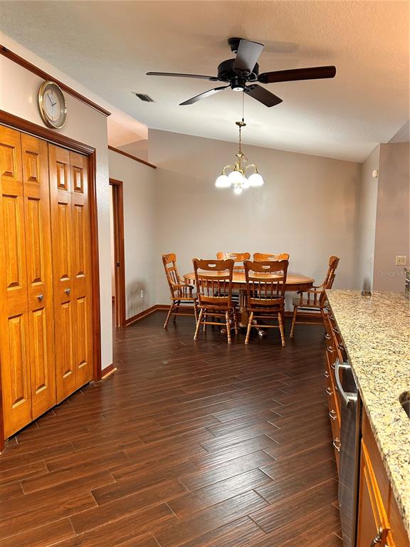 2284 Champlain Avenue Spring Hill, FL 34609 - Photo 14 of 28 a view of a dining room with furniture wooden floor and chandelier