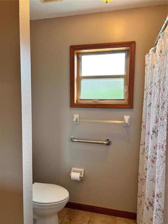 2284 Champlain Avenue Spring Hill, FL 34609 - Photo 17 of 28 a bathroom with a toilet a sink and a window