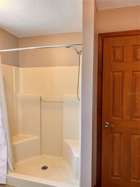 2284 Champlain Avenue Spring Hill, FL 34609 - Photo 19 of 28 a bathroom with a glass shower door