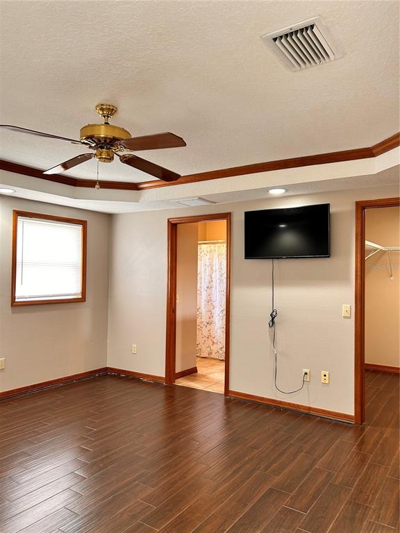 2284 Champlain Avenue Spring Hill, FL 34609 - Photo 20 of 28 a view of a livingroom with wooden floor and a ceiling fan
