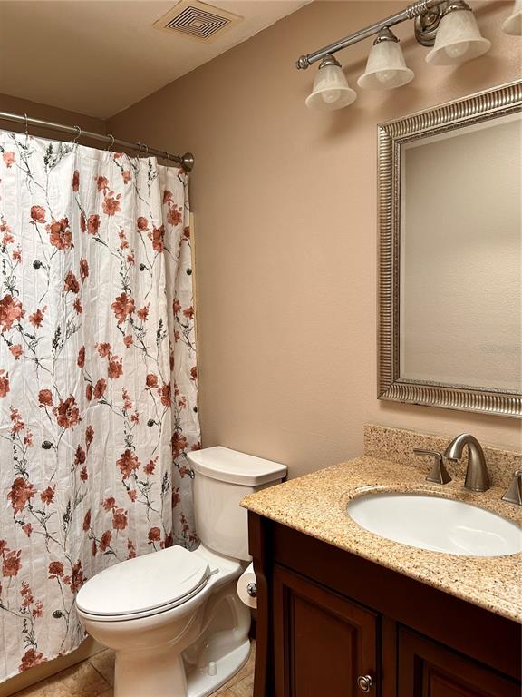 2284 Champlain Avenue Spring Hill, FL 34609 - Photo 25 of 28 a bathroom with a granite countertop sink toilet and a mirror