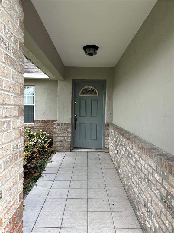 2284 Champlain Avenue Spring Hill, FL 34609 - Photo 3 of 28 a view of entryway with a flower garden