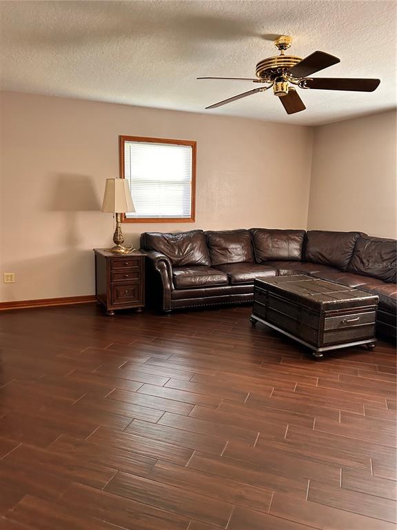 2284 Champlain Avenue Spring Hill, FL 34609 - Photo 10 of 28 a living room with furniture and a ceiling fan