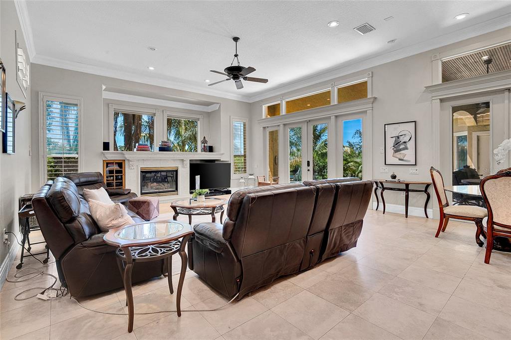 8707 Silverthorn Road Seminole, FL 33777 - Photo 12 of 58 a living room with furniture a fireplace and a flat screen tv
