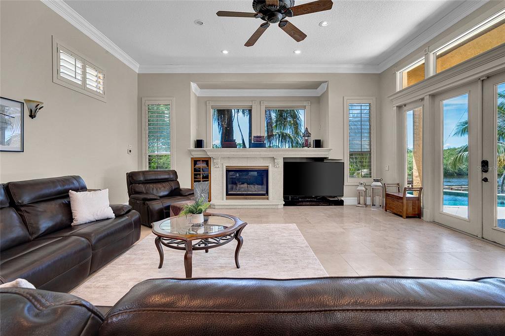 8707 Silverthorn Road Seminole, FL 33777 - Photo 13 of 58 a living room with furniture and a fireplace