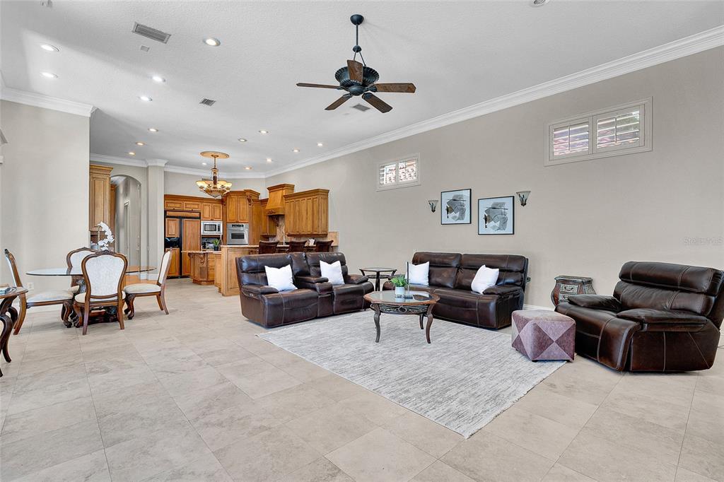 8707 Silverthorn Road Seminole, FL 33777 - Photo 14 of 58 a living room with furniture and a chandelier